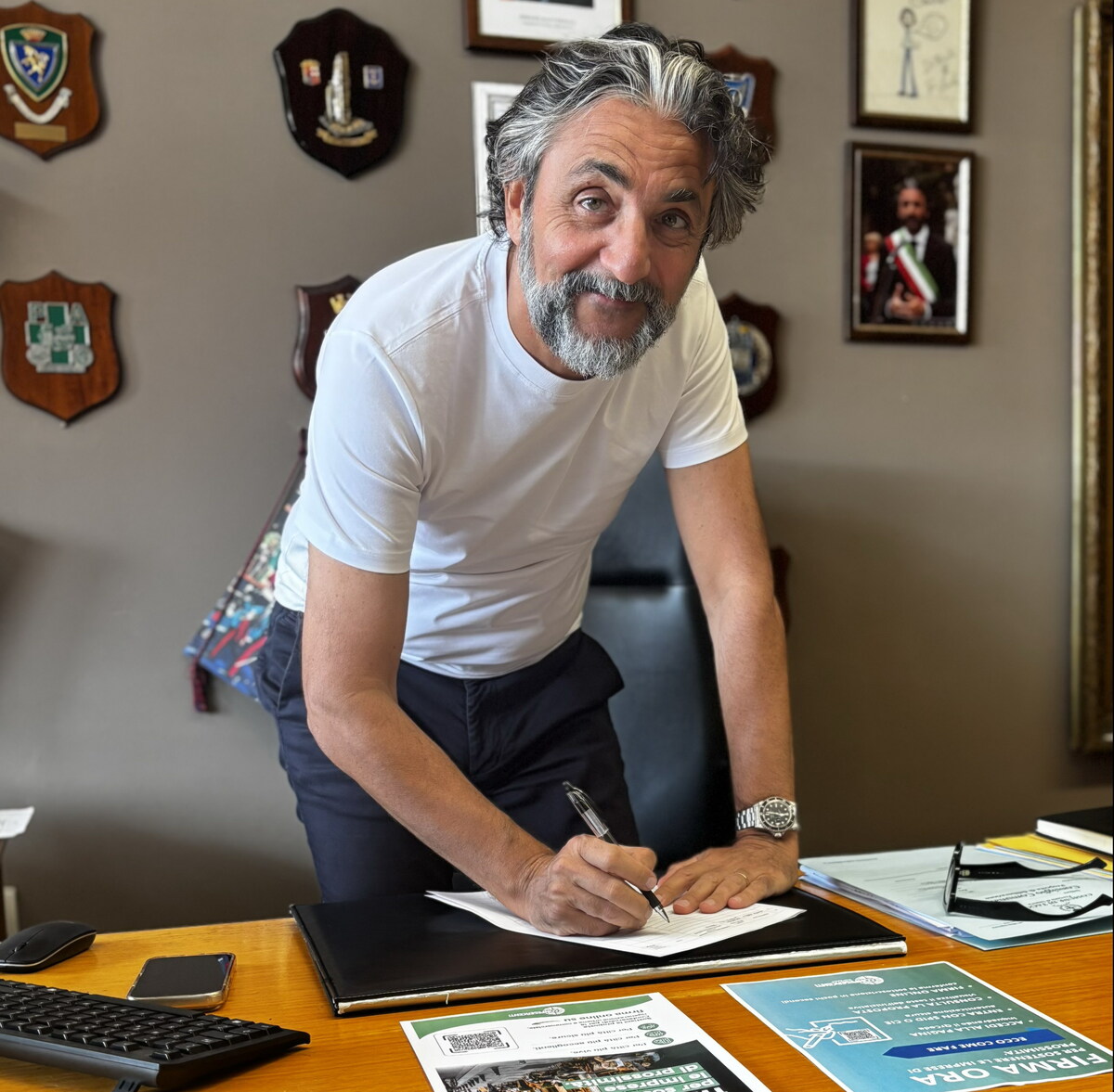 Firma documento su tavolo durante raccolta firme per legge su negozi di vicinato