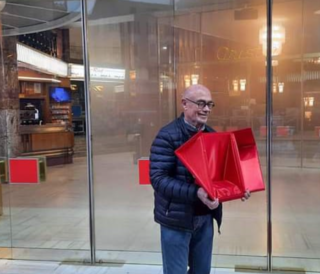 Il patron dell'Ariston, Walter Vacchino, mostra la ritrovata custodia del premio di Angelina Mango